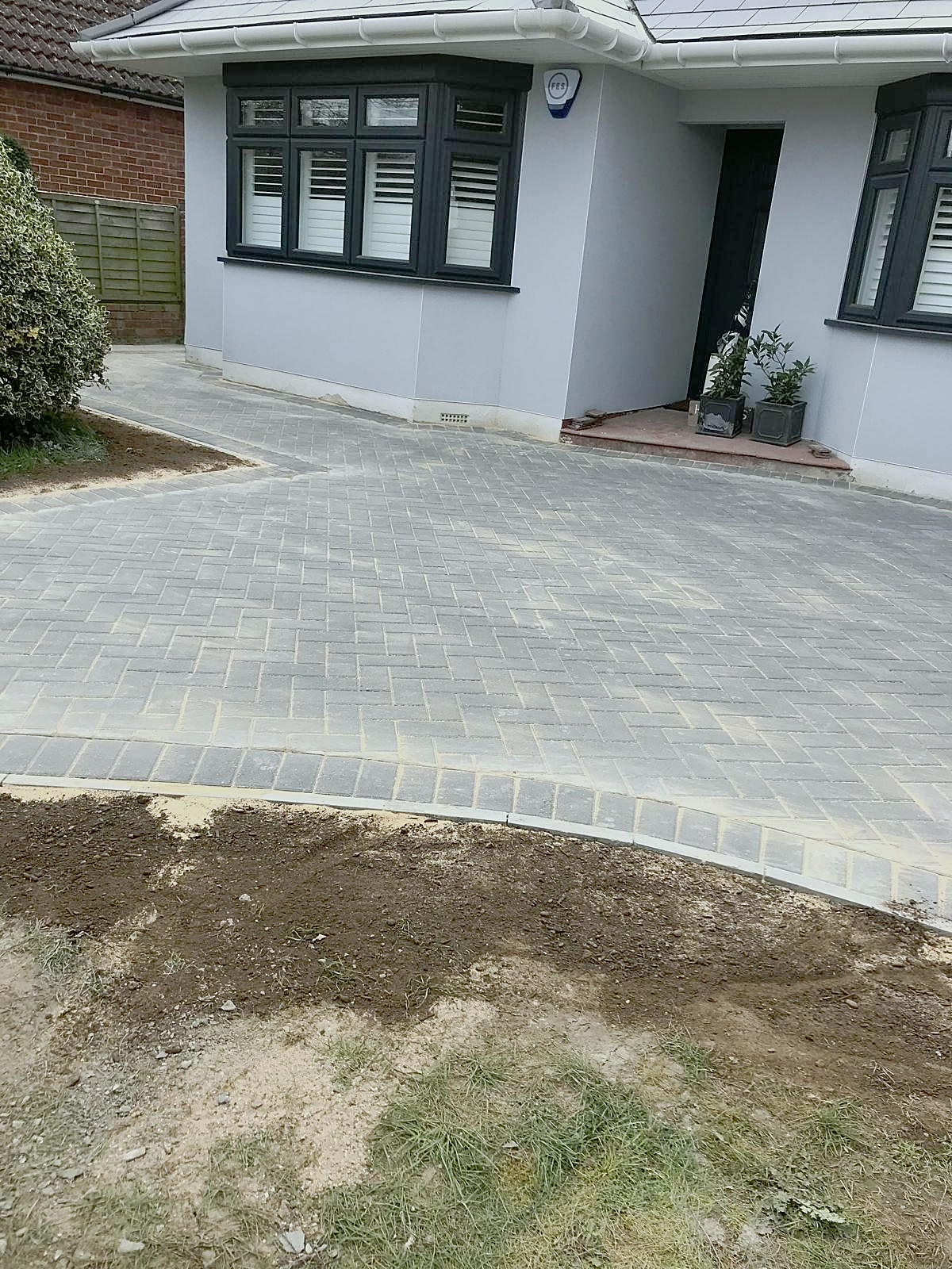 Block-paved driveway in front of a bungalow