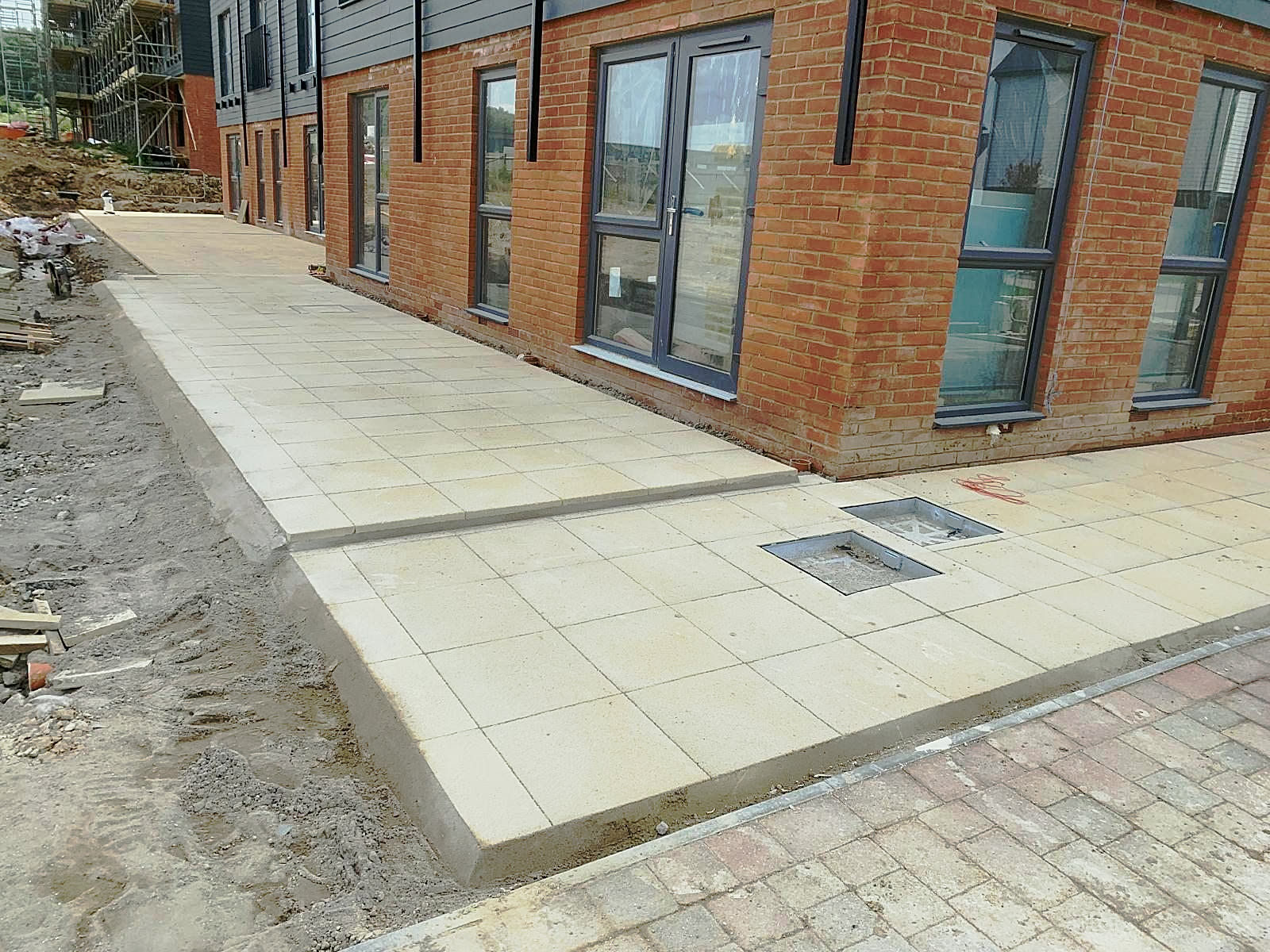 Slab patio with drainage covers set in