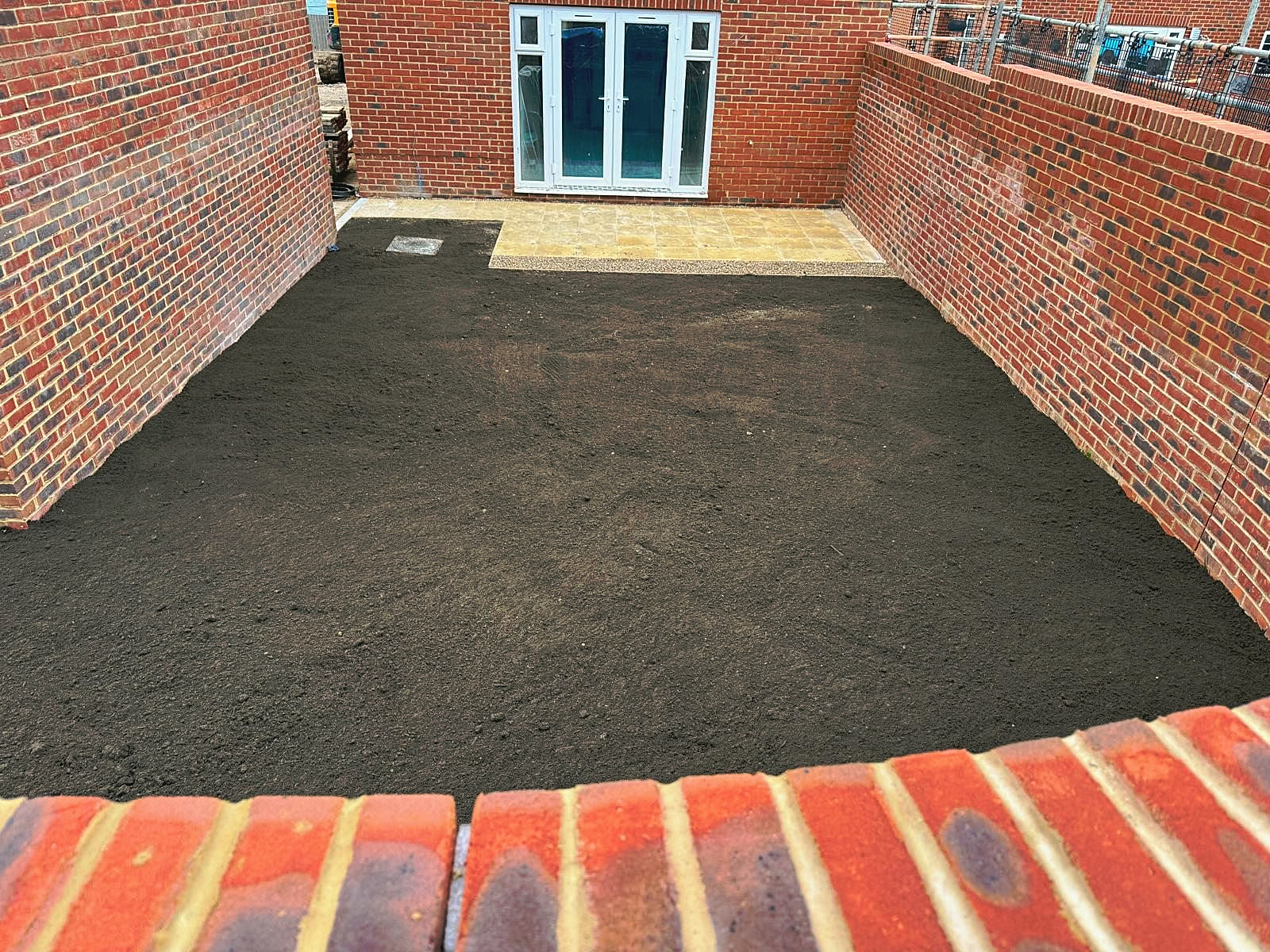 New brick garden walls, ground levelled for the patio