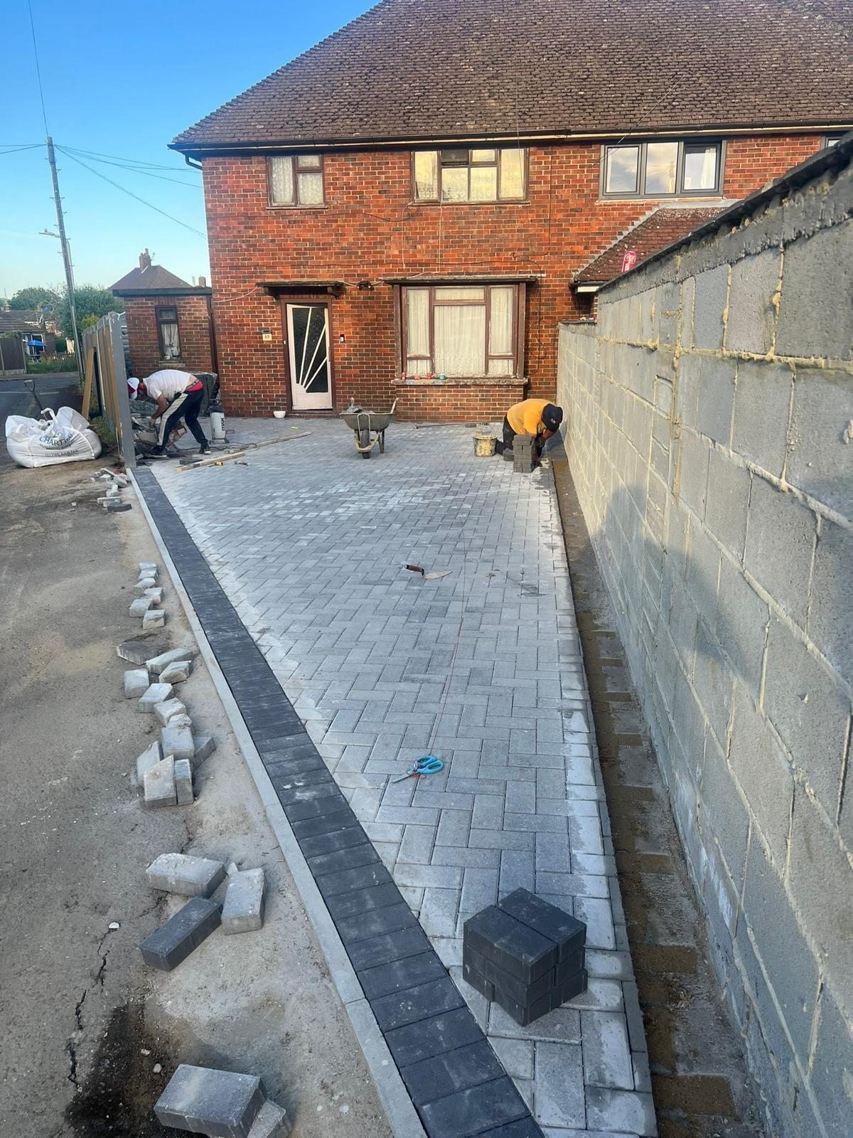 Herringbone block paving going down beside the house